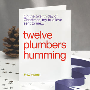 A funny christmas card with the twelve days of christmas lyric altered to 'twelve plumbers humming'.