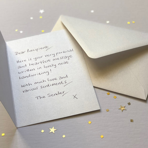 A luxury greetings card and envelope showing a handwritten message inside.