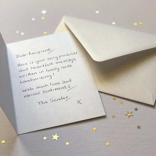 A luxury greetings card and envelope showing a handwritten message inside.