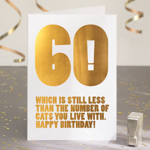 A funny 60th birthday card with the text '60, which is still less than the number of cats you live with'.