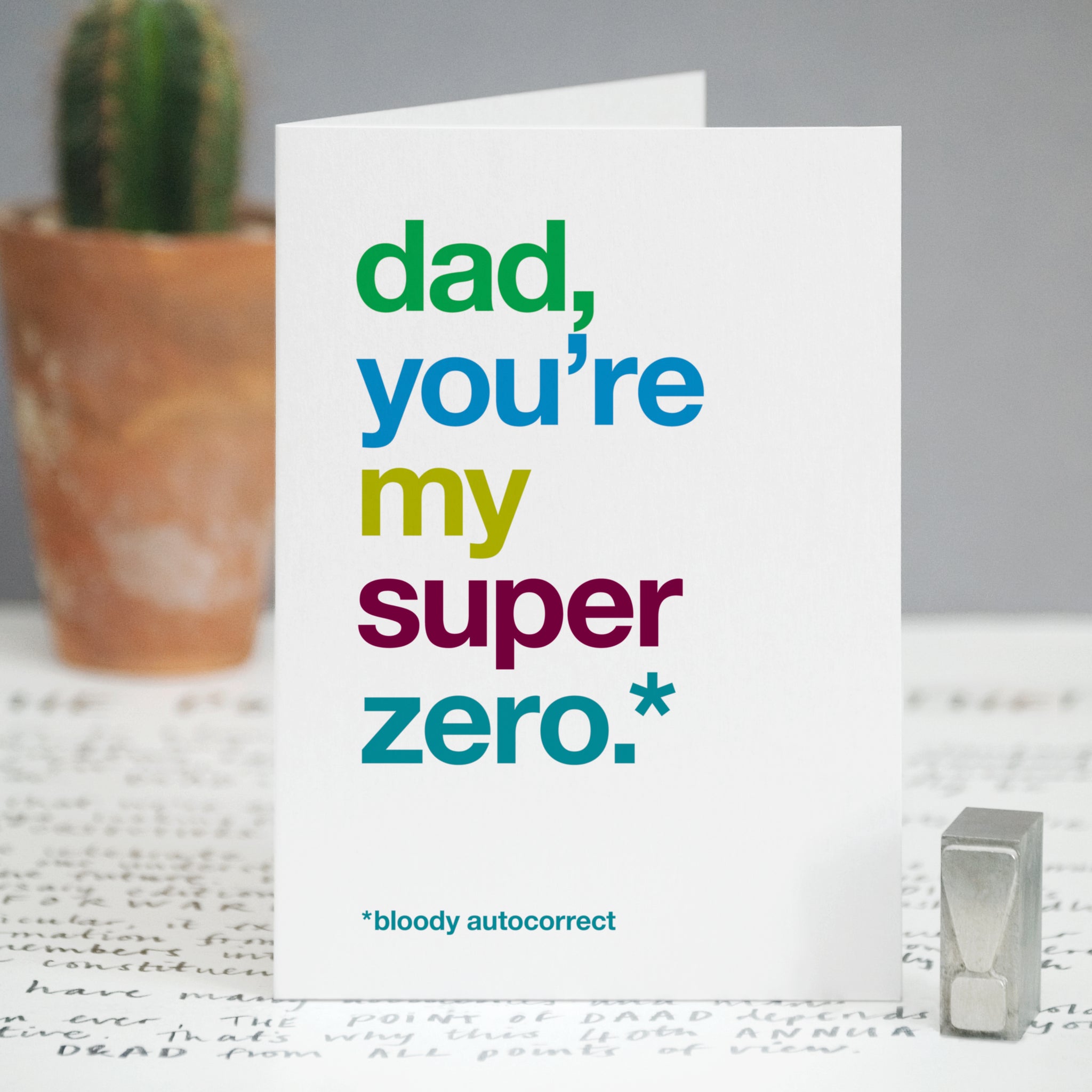 A card with the text 'dad, you're my super zero, bloody autocorrect'.