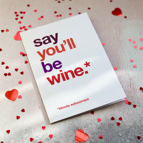 A funny valentine's day card autocorrected to 'say you'll be wine'.