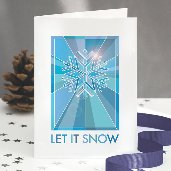 A stained glass christmas card showing a graphic snowflake design.