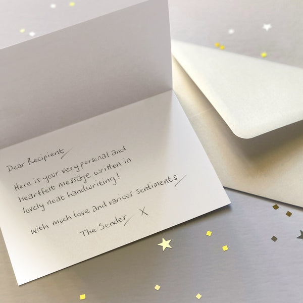 A luxury greetings card and envelope showing a handwritten message inside.