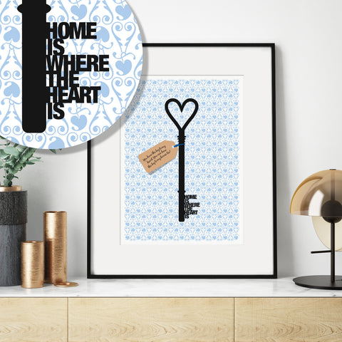 A framed print showing a key silhouette with the words 'home is where the heart is' formed from the teeth of the key.
