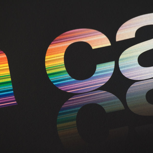 Close detail of rainbow colours fading away within a typeface