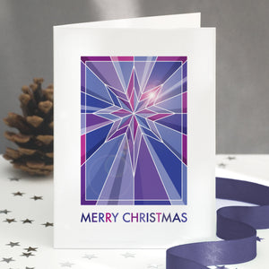 A stained glass christmas card showing a geometric star design.