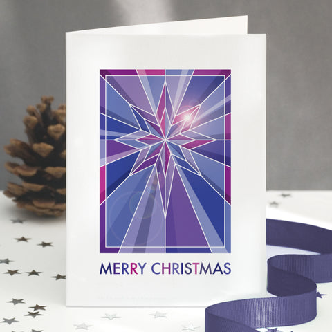 A stained glass christmas card showing a geometric star design.